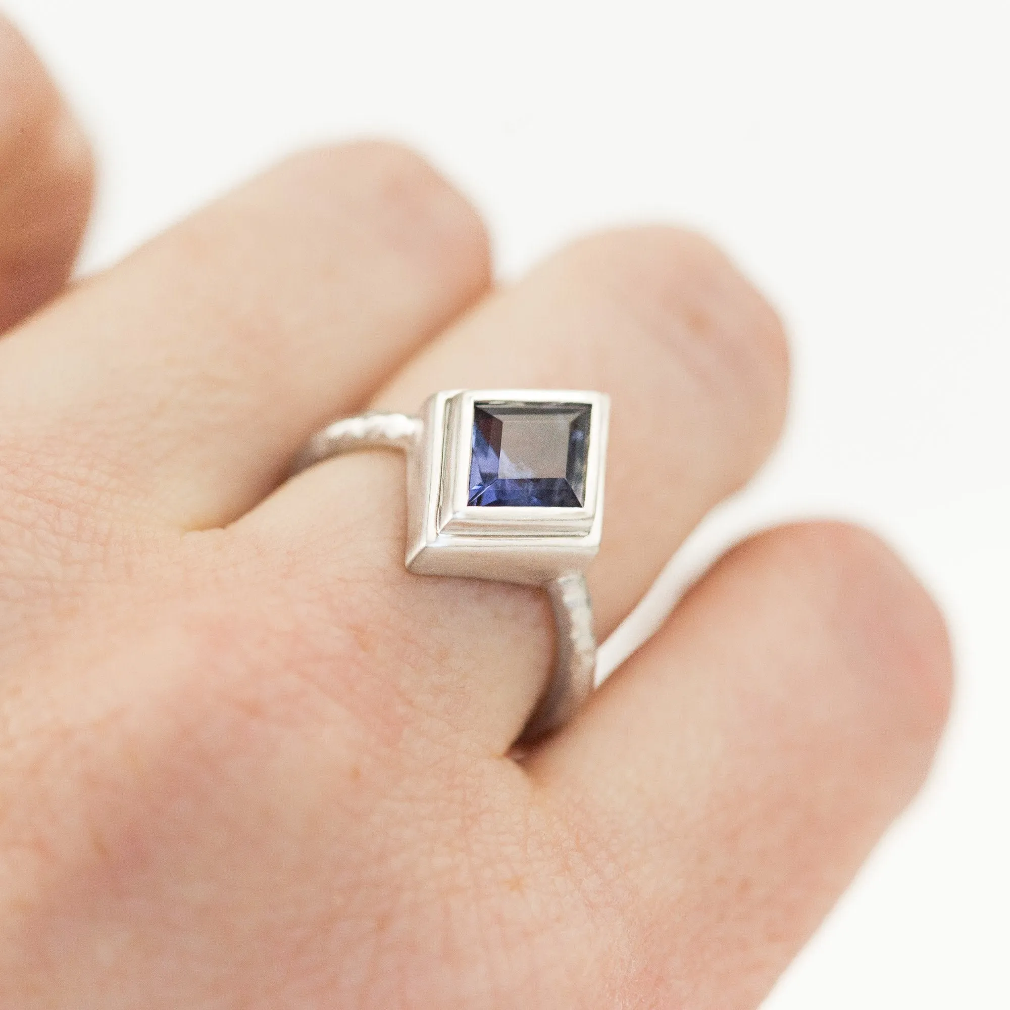 Kite Shaped Purple Blue Iolite in Evergreen Carved 18k White Bezel with satin finish